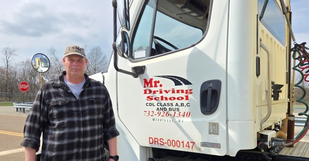 Student next to Mr. Driving School CDL truck