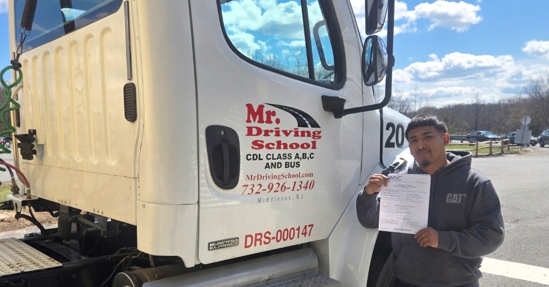 CDL graduate holding certification papers