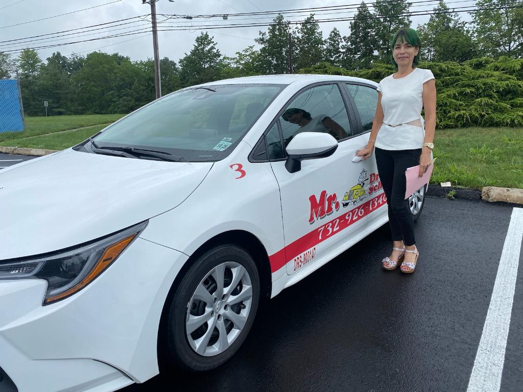 Student with Mr. Driving School car after passing